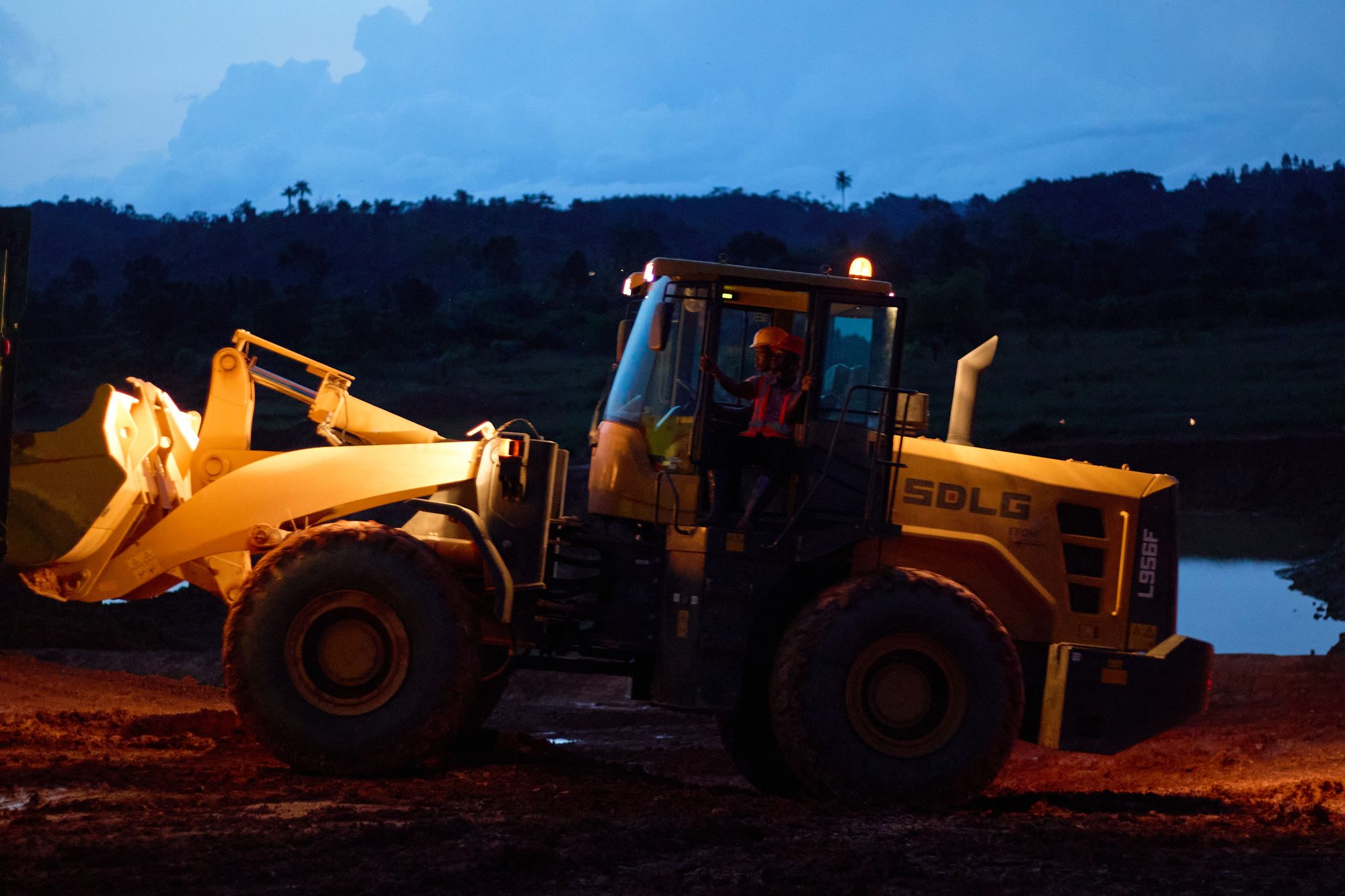 A wheel loader working at dusk at Dompim Pepesa Mines